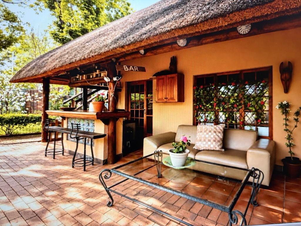 The thatched patio terrace, set with outdoor seating